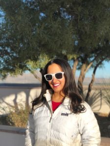 Photo of Paula Pant in a white coat with white sunglasses