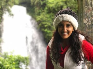 Photo of Paula Pant in front of a waterfall