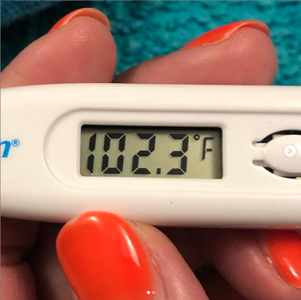 Photo of thermometer that reads 102.3 degree fever