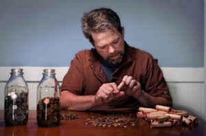 JD Roth counting coins at a table