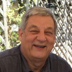 JL Collins, expert in financial independence, smiling in front of the camera.
