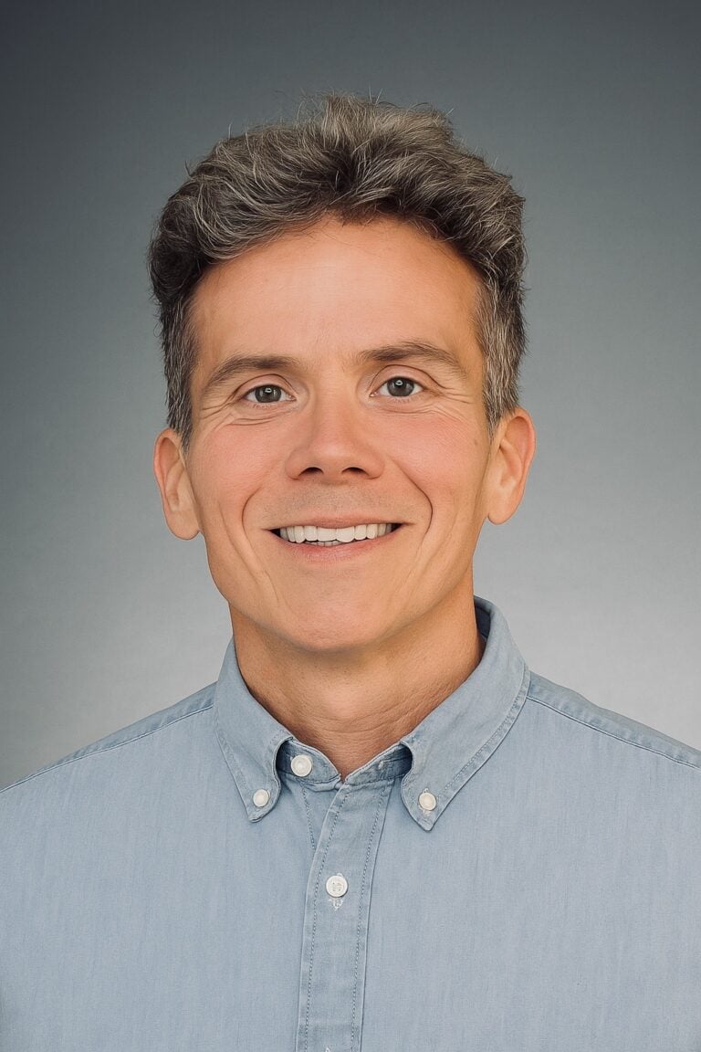 Dr. Daniel Crosby, an expert in Financial Success, smiling in front of the camera for a formal shoot.